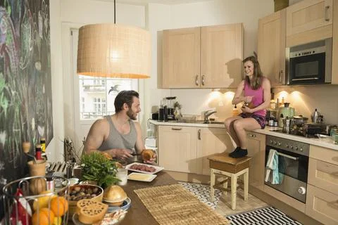 Couple in kitchen preparing breakfast, Munich, Bavaria, Germany Stock Photos
