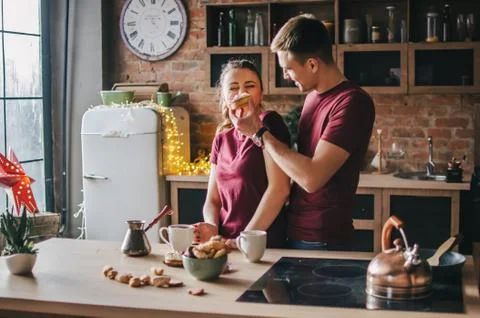 A couple in the kitchen is preparing coffee 写真素材