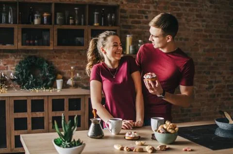 A couple in the kitchen is preparing coffee Stock Photos