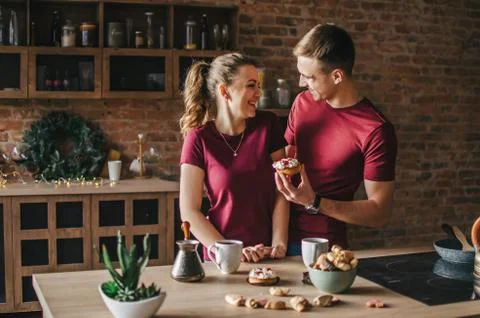 A couple in the kitchen is preparing coffee Stock Photos