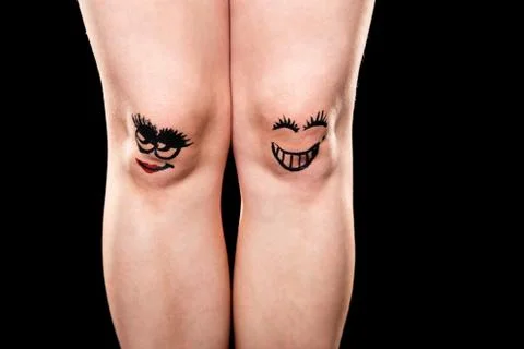 Couple of knees with faces 库存照片