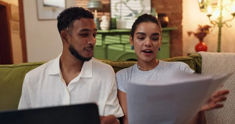 Couple, laptop and discussion with document, mortgage and financial planning or Stock Footage 308625704