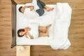 The couple laugh on the bed. View from above Photo