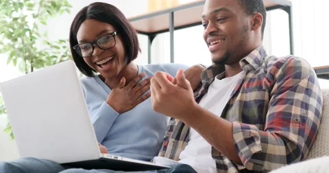 Couple laughing and talking while using laptop Stock-Footage 149502213