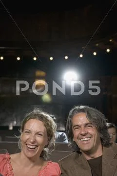 A couple laughing in a movie theater Stock Photos