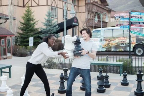 Couple Laughs while Playing Together on Date Stock Photos