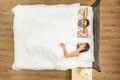 The couple lay on the bed. View from above Photo