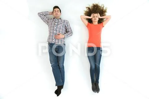 The couple lay on the white floor. View from above Stock Photos