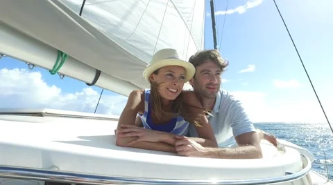 Couple laying on a sailboat deck during cruise Stock Footage 58991371