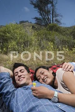 Couple laying on sleeping bag hugging Stock Photos