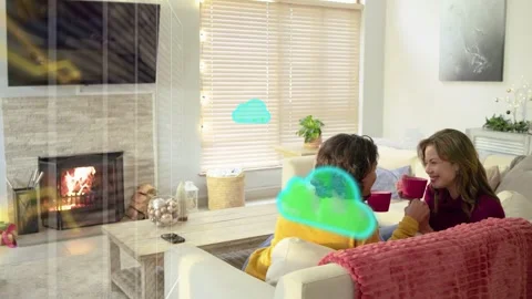 Couple leaning sofa raising red mugs under teal clouds appearing near window Stock Footage 333774378
