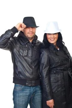 Couple in leather jackets and hats Stock Photos
