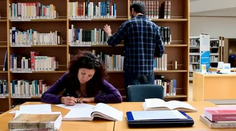 Couple in a library man explaining Stock Footage 22179218