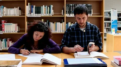 Couple in a library reading together Video stock 22182453
