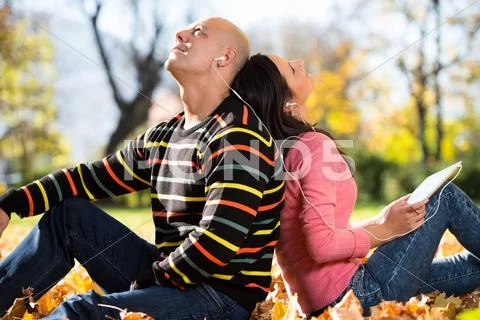 Couple Listening Music In The Autumn Sunshine
