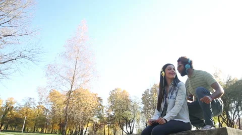 Couple listening to music on headphones and moving in the rhythm Stock Footage 59554784
