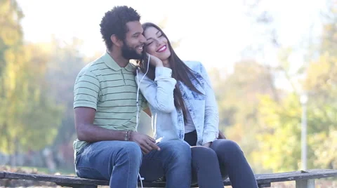 Couple listening to music together, sharing earphones Stock Footage 59555751