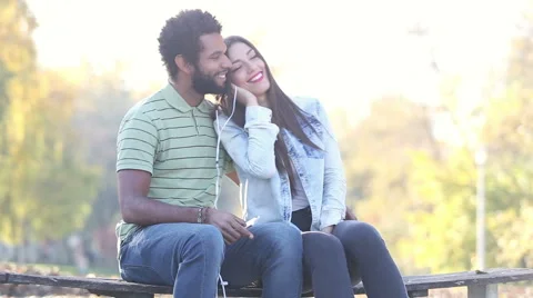 Couple listening to music together, sharing earphones Stock Footage 59555755