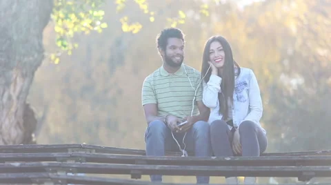 Couple listening to music together, sharing earphones Stock Footage 59555781