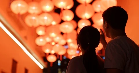 Couple look at the beautiful red lantern for chinese new year at night Stock Footage 102246174