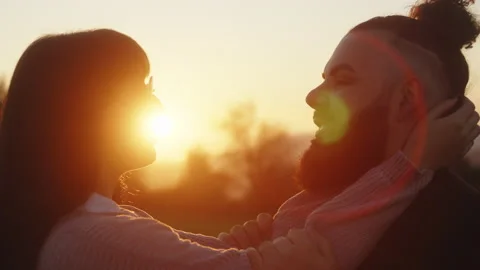 Couple look into each other's at sunset Stock Footage 230235374
