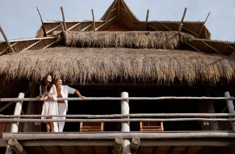 Couple looking off balcony Stock Photos