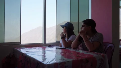 A couple looking at a beautiful view of the mountains with the fresh air in an A 库存影片 198759687