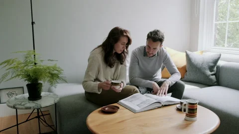 Couple looking at book and having a discussion Video stock 130640935
