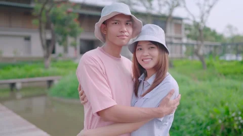 Couple looking at camera and hugging while looking at each other standing at hom Stock Footage 265052533