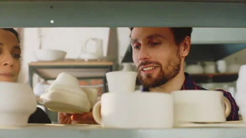 Couple Is Looking On Ceramic Items Stock Footage 169932901