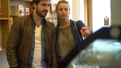 Couple looking at display case in delicatessen Stock Footage 63300760