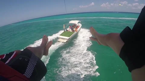 A couple looking down at the boat while parasailing Stock Footage 45624304