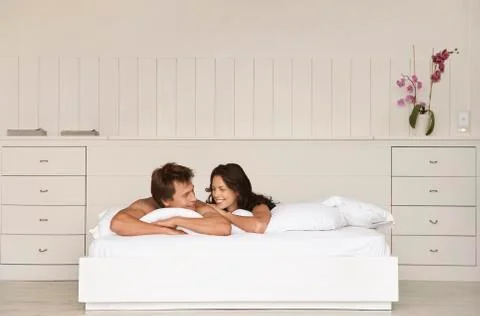 Couple Looking At Each Other In Bed Stock Photos