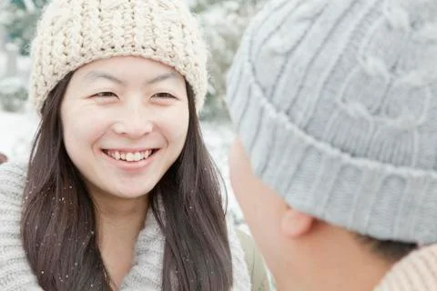 Couple looking at each other in snow Stock Photos