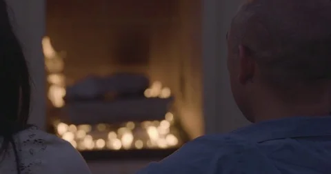 Couple looking at the fireplace Stock Footage 83186740