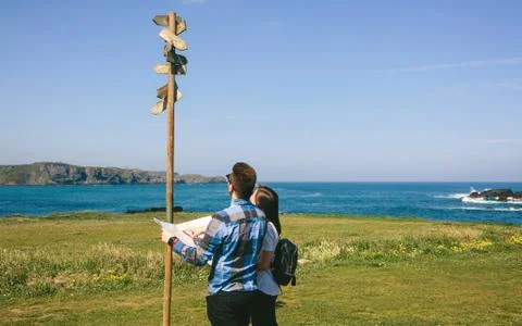 Couple looking a map and direction sign Stock Photos