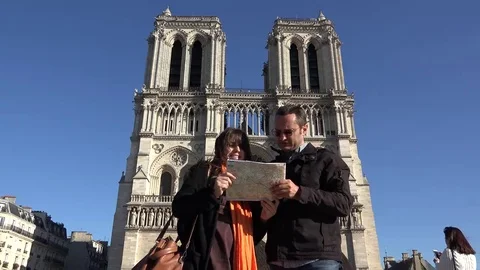 Couple looking on the map close notre dame de paris, art tourism Stock Footage 69181695