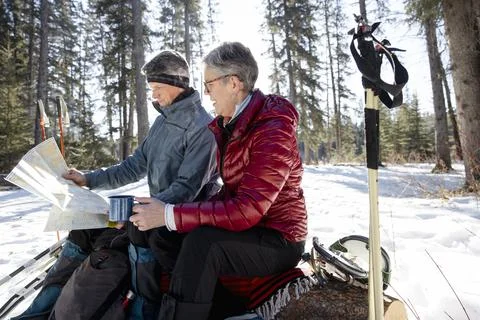 Couple looking at map on winter hike Fotos Stock
