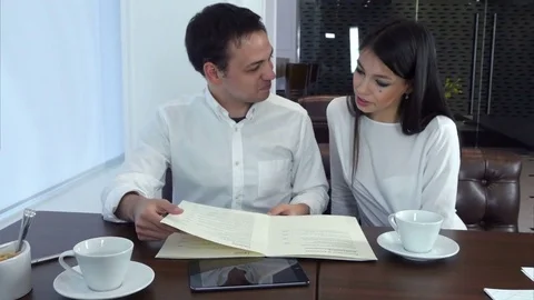 Couple looking at menu and choosing what to order for lunch Vídeos de archivo 72099341