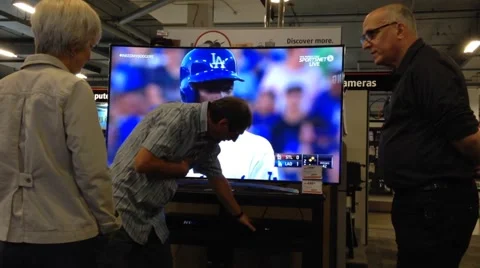 Couple looking for new tv in electronics store Stock Footage 39964614