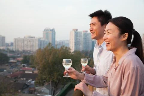 Couple Looking Out Over Cityscape Stock Photos