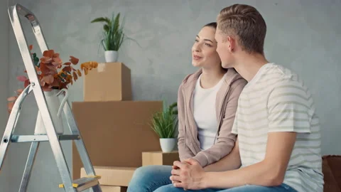 Couple Looking out of Window in There new Flat. Couple Moved in a new Home Stock Footage 217738091