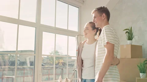 Couple Looking out of Window in There new Flat Girl Pointing. Couple Moved in a Stock Footage 217741636
