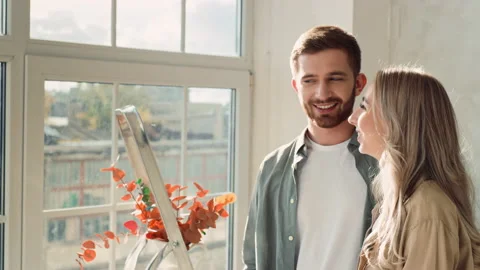 Couple Looking out of Window in There new Flat. Couple Moved in a new Home Stock Footage 217757689