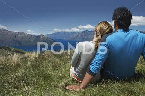 Couple Looking Over Lake And Hills Stock Photos