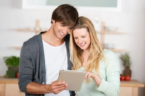 Couple looking for recipes Stock Photos