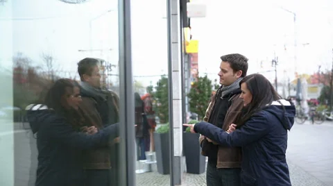 Couple looking at showcase of retail store Stock Footage 33079090