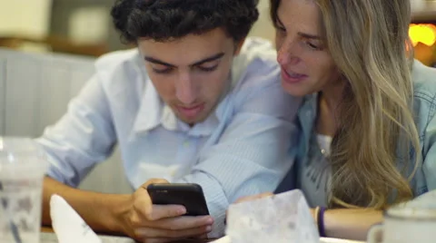 Couple looking at smartphone together Stock Footage 63305319