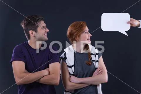 Couple looking at speech bubble Stock Photos