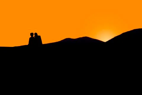 Couple looking at the sunset. 스톡 사진